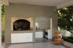 a kitchen with a fireplace in the middle of it at Apartments and rooms with parking space Vodice - 6260 in Vodice