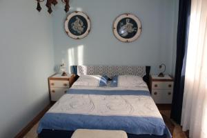 a bedroom with a bed and two pictures on the wall at Apartments with a parking space Vodice - 6271 in Vodice