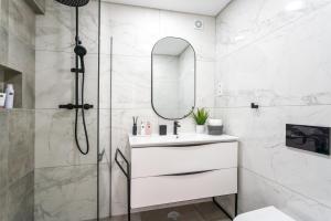 a bathroom with a shower and a sink and a mirror at Privilege Deluxe Apartment Casa Mãe, Faro in Faro +27 photos