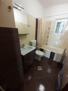 a bathroom with a toilet and a sink at Apartments by the sea Kustici, Pag - 6320 in Kustići