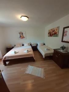 a hotel room with two beds in a room at Apartments by the sea Kustici, Pag - 6320 in Kustići