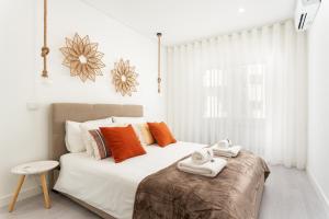 a bedroom with a large bed with towels on it at Privilege Deluxe Apartment Casa Mãe, Faro in Faro