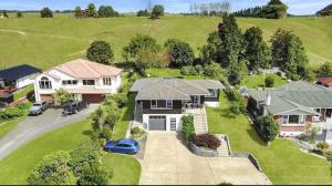 an aerial view of a house with a driveway at Tranquil mountain peak in Rotorua