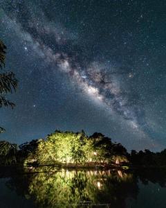 a night view of the milky way over a body of water at Tad Lo Fandee Island - Bolaven Loop Pakse in Ban Kiangtat
