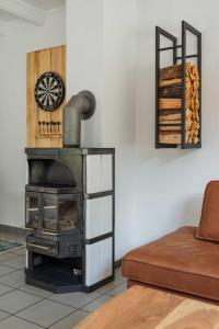 a stove in a living room with a couch at Gemütliches Fachwerkhaus im Herzen Nideggens in Nideggen