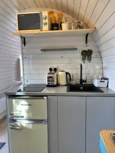a small kitchen with a sink and a stove at Finest Retreats - Clotted Cream Cabin in East Looe