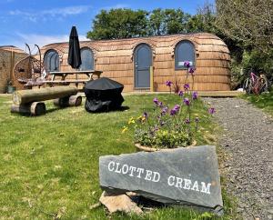 aented greenhouse with a sign in front of a building at Finest Retreats - Clotted Cream Cabin in East Looe