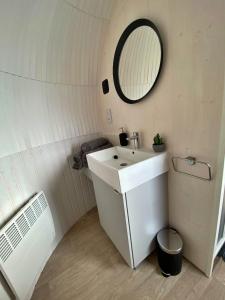 a bathroom with a sink and a mirror at Finest Retreats - Jam First Cabin in East Looe