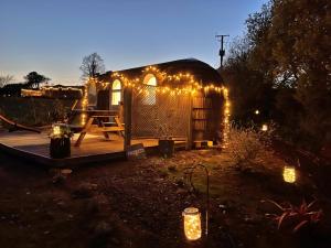 a yurt with lights in a yard at night at Finest Retreats - Prosecco Cabin in East Looe