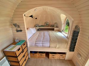 a bed in a small room in a tiny house at Finest Retreats - Prosecco Cabin in East Looe