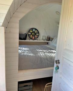 a bedroom with a bed in a small room at Finest Retreats - Proper Job Cabin in East Looe