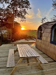 a wooden picnic table on a deck with a rv at Finest Retreats - Proper Job Cabin in East Looe