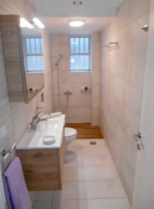 a bathroom with a sink and a toilet at Katerina summerhouse in Dhaskalión