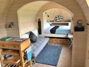 a small bedroom with a bed and a desk at Finest Retreats - The Pasty Cabin in East Looe