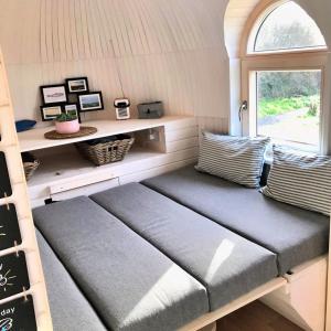 a bench in a tiny house with a window at Finest Retreats - The Pilchard Cabin in East Looe