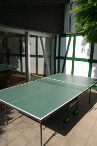 a green ping pong table in front of a building at Gemütliches Fachwerkhaus im Herzen Nideggens in Nideggen