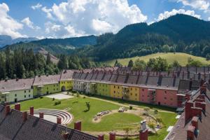 an aerial view of a village with mountains in the background at Erzberg Alpin Resort by ALPS RESORTS in Eisenerz