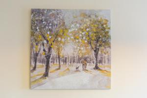 a painting of a woman and two dogs in the snow at Velvet 1-bedroom penthouse, Clockhouse, Hoddesdon in Hoddesdon