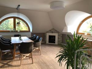 a dining room with a table and chairs and a fireplace at Sporthotel Fuchsbachtal in Barsinghausen