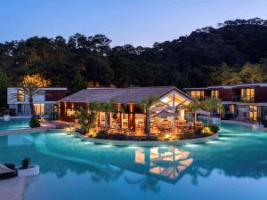 a resort with a swimming pool at night at Rixos Premium Tekirova - The Land of Legends Access in Tekirova