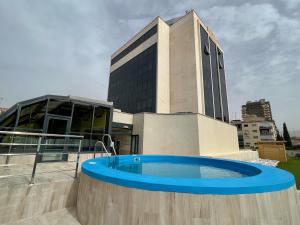 a building with a swimming pool in front of a building at Turia Granada in Granada