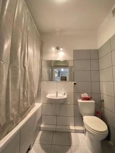 a bathroom with a toilet and a sink at Murano Apartaments Nova Praga in Warsaw