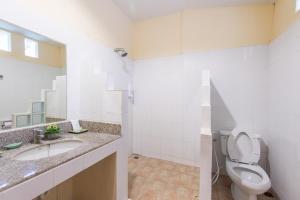 a bathroom with a toilet, sink, and shower stall at Twin Bay Resort - SHA Extra Plus in Ko Lanta