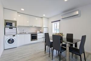 a kitchen with a table and chairs in a kitchen at Casa de Cristelos in Lousada