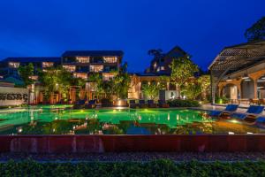 a swimming pool at night with a house in the background at Thai Fight Hotel in Lamai