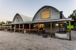an exterior view of a house with a gambrel roof at Arch Cabins Self Catering Homes Storms River in Stormsrivier