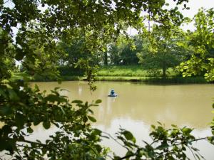 a person in a boat on a lake at The Chestnuts Holiday Cottages in Burgh le Marsh