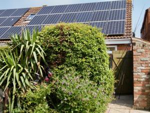 a house with solar panels on the roof at The Chestnuts Holiday Cottages in Burgh le Marsh