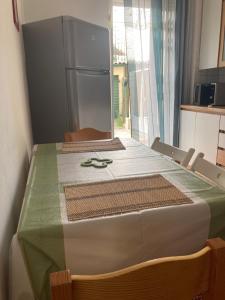 a kitchen with a table with a refrigerator at Casa Le Felci in Florence