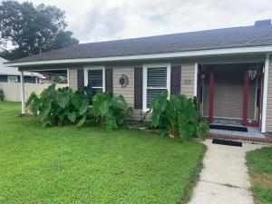a house with a bunch of plants in the yard at Cheerful two bedroom house 1.5 miles from beach. in Myrtle Beach