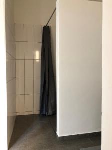 a bathroom with a robe hanging on a wall at Casa Palmeira in Lazareto