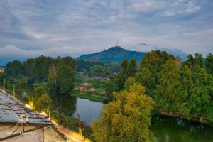 an aerial view of a river with trees and a mountain at KAREEM RESIDENCY in Srinagar