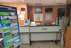 a reception desk in a store with a sign at Apartamentos Paradis Blanc 3000 in Pas de la Casa