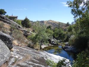 a river in the middle of a rocky canyon at Salto do Lobo - Montain houses with private river in Penhas da Saúde