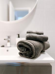 a pile of towels sitting on top of a bathroom counter at Apartamento Maëlle Playa Blanca in Playa Blanca