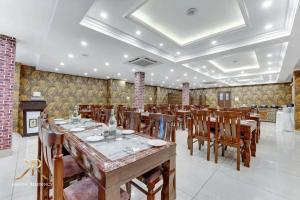 a dining room with a long table and wooden chairs at KAREEM RESIDENCY in Srinagar