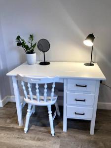 a desk with a chair and a lamp and a potted plant at Kingswood Gardens No. 4 in George