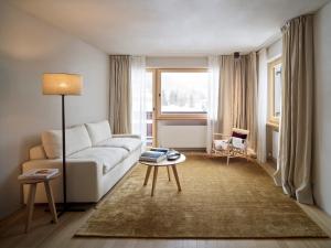 a living room with a couch and a table at Hotel Schwarzwand in Lech am Arlberg