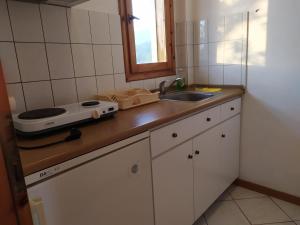 a kitchen counter with a sink and a toaster on it at Studios Thanasis in Limenaria