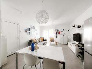 a white living room with a white table and chairs at Apartamento Maëlle Playa Blanca in Playa Blanca