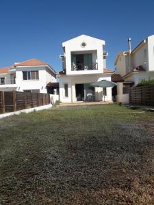 a large yard in front of a house at SEAFRONT BEACH PARTY VILLA in Perivolia