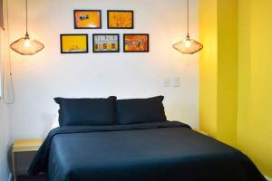 a bedroom with a bed and three pictures on the wall at Espectacular apt 3 habitaciones deluxe! in Envigado +4 photos
