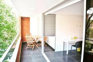 a small balcony with a table and chairs on it at Espectacular apt 3 habitaciones deluxe! in Envigado