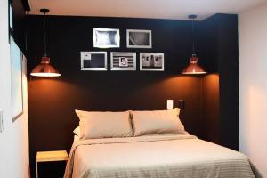 a bedroom with black walls and a bed with two lights at Espectacular apt 3 habitaciones deluxe! in Envigado