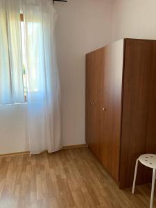a room with a wooden cabinet and a window at Sunny Home in Sandanski