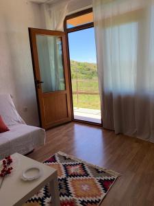 a living room with a door open to a patio at Sunny Home in Sandanski